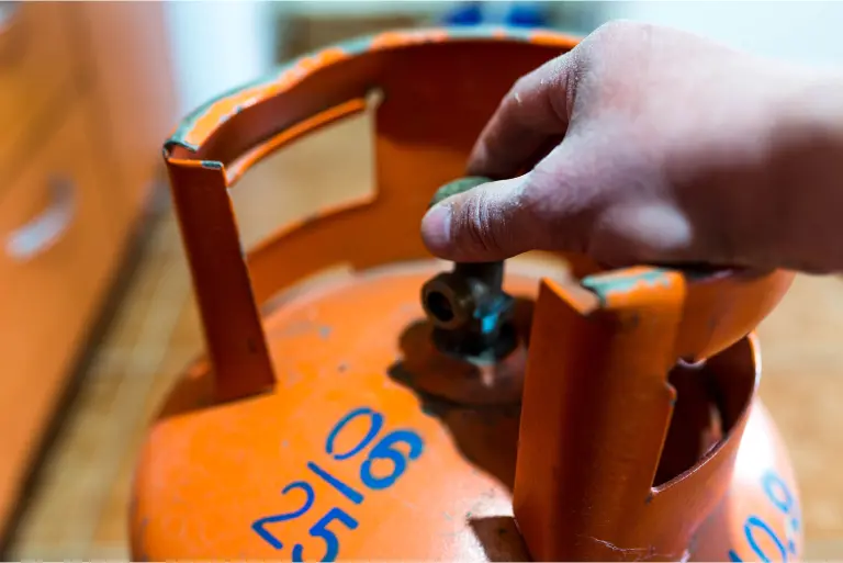 Top LPG Gas Booking Providers Person holding an orange gas cylinder, ready for use shows to lpg gas booking