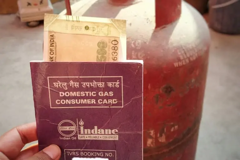 indane gas booking phone number Cylinder with book and 500 rs note inside the book to bookindane gas booking phone number