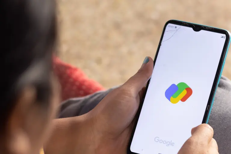 Person looking at mobile while opening google pay app in screen 