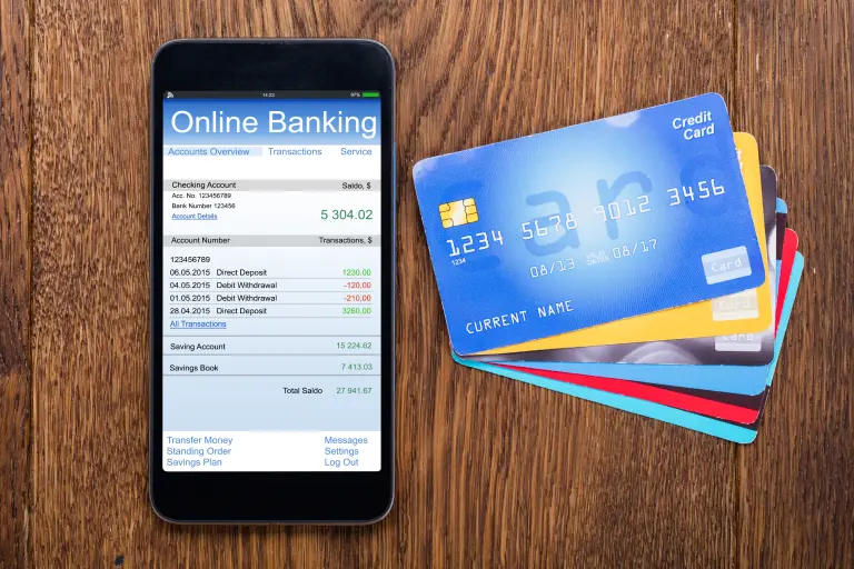 Online banking and credit cards neatly arranged on a table means
