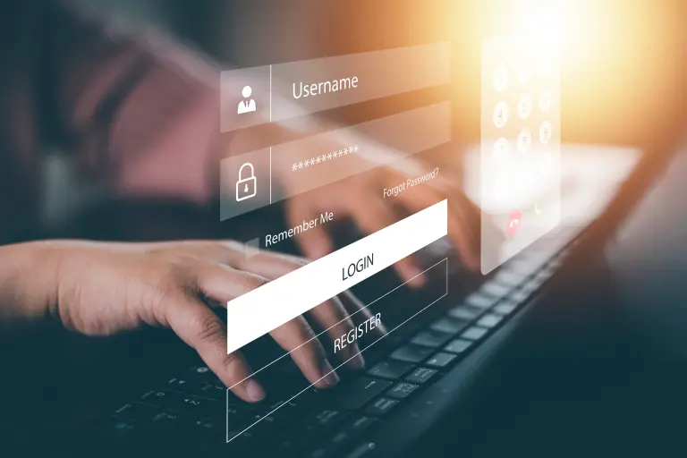 A person typing on a laptop with a login screen displayed means to check icici account balance through internet banking